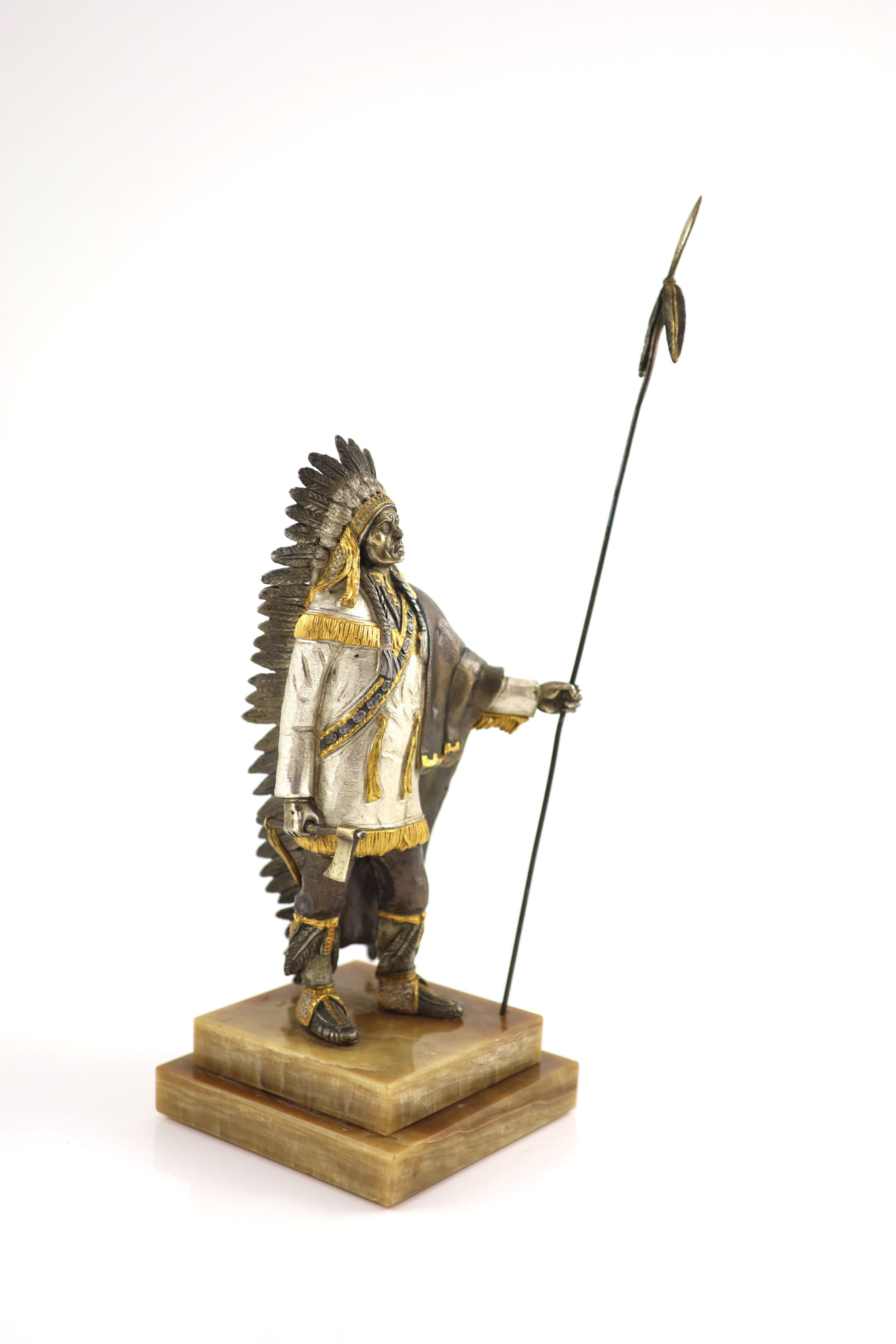 After Carl Kauba, a gilded, silvered and patinated bronze figure of a Native American chieftain, H 36 cm. (from tip of spear)